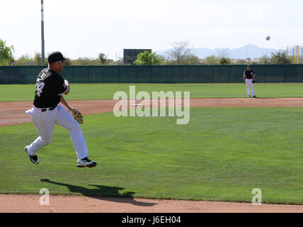 Michael Olt, Chicago White Sox third baseman, slings a baseball to home  plate during Spring training March 8, 2016, in Goodyear, Ariz. The White Sox  organization routinely invites Luke Air Force Base Airmen to attend  practices, games, and functions during Spring training. (U.S. Air Force  photo by Airman 1st Class Ridge Shan) Stock Photo