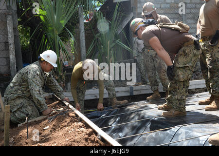 CONCHAGUA, El Salvador (Aug. 16, 2016) –Steelworker Second Class Moises Vargas demonstrates the proper spacing for rebar to his crew, all assigned to Navy Mobile Construction Unit 133, in preparation of pouring the foundation for a new community center during Southern Partnership Station 2016 (SPS-16).  SPS-16 is an annual series of U.S. Navy deployments, fostering a lasting relationship with the people of Central and South America through exercises, operations and community relations projects. (U.S. Navy photo by Mass Communication Specialist 1st Class Kimberly Clifford/Released) Stock Photo