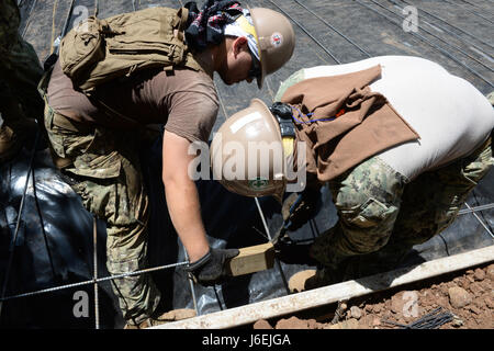 CONCHAGUA, El Salvador (Aug. 16, 2016) – Builder Second Class Thomas Rambo and Construction Electrician Third Class Bryan Terrazas, both assigned to Navy Mobile Construction Unit 133, space and tie rebar in preparation for pouring the foundation of a new community center during Southern Partnership Station 2016 (SPS-16).  SPS-16 is an annual series of U.S. Navy deployments, fostering a lasting relationship with the people of Central and South America through exercises, operations and community relations projects. (U.S. Navy photo by Mass Communication Specialist 1st Class Kimberly Clifford/Rel Stock Photo