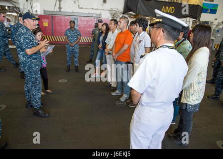 160820-N-XK809-175 OKINAWA, Japan (Aug. 20, 2016) Capt. Jeffrey Ward, commanding officer of USS Bonhomme Richard (LHD 6), welcomes officers of the Japanese Maritime Self Defense Force (JMSDF) and members of the local community prior to a ship tour. The tour provided community members an opportunity to see Bonhomme Richard and learn about the U.S. Navy. Bonhomme Richard, flagship of the Bonhomme Richard Expeditionary Strike Group, is operating in the U.S. 7th Fleet area of operations in support of security and stability in the Indo-Asia-Pacific region. (U.S. Navy photo by Mass Communication Spe Stock Photo