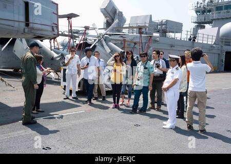 160820-N-XK809-245 OKINAWA, Japan (Aug. 20, 2016) Lt. Cmdr. Christopher Dike, guides officers of the Japanese Maritime Self Defense Force (JMSDF) and members of the local community on a tour of the flight deck aboard amphibious assault ship USS Bonhomme Richard (LHD 6). The tour provided community members an opportunity to see Bonhomme Richard and learn about the U.S. Navy. Bonhomme Richard, flagship of the Bonhomme Richard Expeditionary Strike Group, is operating in the U.S. 7th Fleet area of operations in support of security and stability in the Indo-Asia-Pacific region. (U.S. Navy photo by  Stock Photo