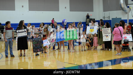 Family members hold signs for Airmen from the 554th RED HORSE Squadron ...