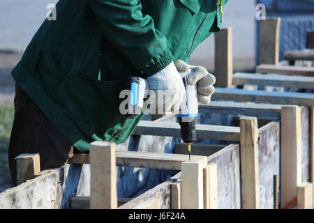 Workers mount the formwork for pouring concrete and tiling. Stock Photo