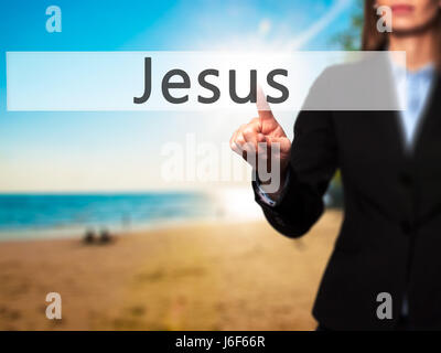 Jesus - Businesswoman hand pressing button on touch screen interface. Business, technology, internet concept. Stock Photo Stock Photo