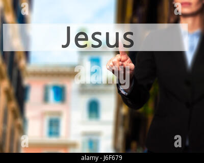 Jesus - Businesswoman hand pressing button on touch screen interface. Business, technology, internet concept. Stock Photo Stock Photo