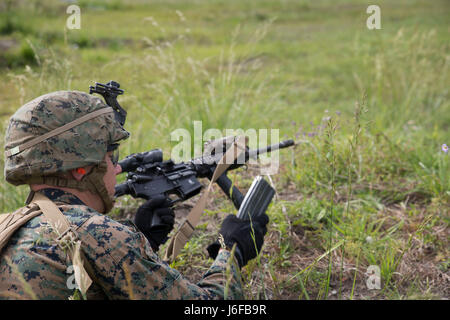 A Marine loads his M4 carbine rifle during a fire team training exercise at Camp Lejeune, N.C., May 9, 2017. The exercise focused on fire team tactics to enhance their combat abilities in both day and night operations. The Marine is with 2nd Battalion, 8th Marine Regiment, 2nd Marine Division. (U.S. Marine Corps photo by Lance Cpl. Patrick Osino) Stock Photo