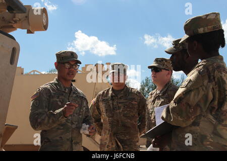 Sgt. 1st Class Joel Vallete, signal section chief of Headquarters Company, 1st Battalion, 8th Infantry Regiment, 3rd Armored Brigade Combat Team, 4th Infantry Division, goes over the safety features on a M113 Command Post Vehicle with a few of his soldiers on May 11, 2017 at Mihail Koglanicenau Air Base, Romania. Vallete spends a lot of his time in and out of the field with his Soldiers training them in their on the job skills, as well as the art of boxing. (Photo taken by Pvt. Nicholas Vidro, 7th Mobile Public Affairs Detachment) Stock Photo