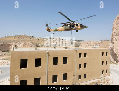 AMMAN, Jordan (May 11, 2017) Members of the Air Force Special Operations from the 23rd Special Tactics Squadron fast rope from a Jordanian UH-60 helicopter during an exercise in support of Eager Lion 2017. Eager Lion is an annual U.S. Central Command exercise in Jordan designed to strengthen military-to-military relationships between the U.S., Jordan and other international partners. This year's iteration is comprised of about 7,200 military personnel from more than 20 nations that will respond to scenarios involving border security, command and control, cyber defense and battlespace managemen Stock Photo
