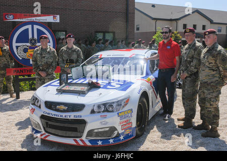 Jimmie Johnson, Lt. Col. Scott Pence, Command Sgt. Maj. Walter Kirk, Command Sgt. Maj. Robert Cobb and Spc. Josh Freier honor Spc. Michael Rodriguez a fallen Paratrooper who was assigned to Bravo Troop, 5th Squadron, 73rd Cavalry Regiment, 3rd Brigade Combat Team, 82nd Airborne Division display a memorial shadow box for the fallen Paratrooper at Fort Bragg, N.C., May. 17, 2017. (U.S. Army photo by Spc. Zackary Nixon) Stock Photo