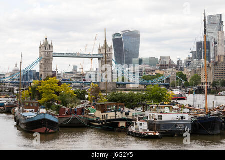 London, UK. 21st May, 2017. People visit the floating Garden Barge Square at Downings Road Moorings, near Tower Bridge on the River Thames, with a backdrop of the Canary Wharf financial district, which are open to the public as part of the National Gardens Scheme Open Day in London on. The Open Garden Scheme allows members of the public access to many gardens which are private for the remainder of the year. Credit: Vickie Flores/Alamy Live News Stock Photo