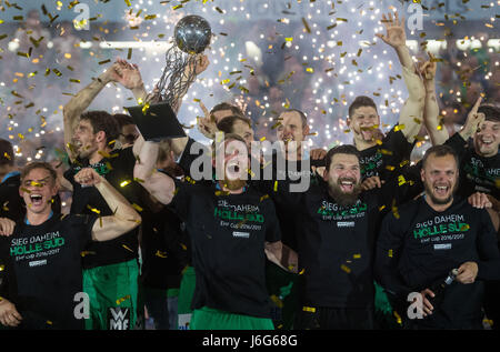 Göppingen's Manuel Spaeth (C) holds the trophy in between his team mates at the award ceremony after the ending of the EHF-Cup handball final match between Berlin Füchse and Frisch Auf Göppingen in the EWS-Aerna in Göppingen, Germany, 21 May 2017. Photo: Marijan Murat/dpa Stock Photo