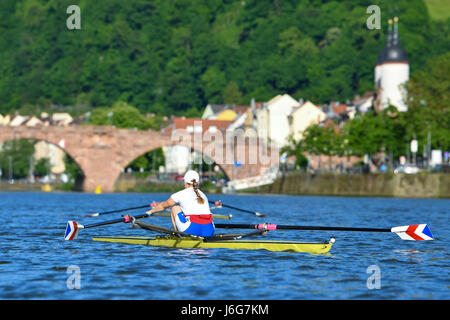 Heidelberg, Germany. 17th May, 2017. A rower makes her way along the Neckar river in her rowing boat in Heidelberg, Germany, 17 May 2017, with the Old Bridge seen in the background. Photo: Uwe Anspach/dpa/Alamy Live News Stock Photo