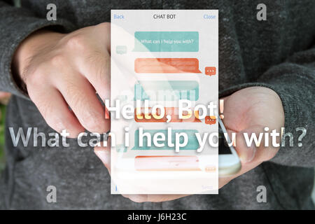 Chat bot and future marketing concept , automatic chatbot message screen with hand holding mobile phone background Stock Photo