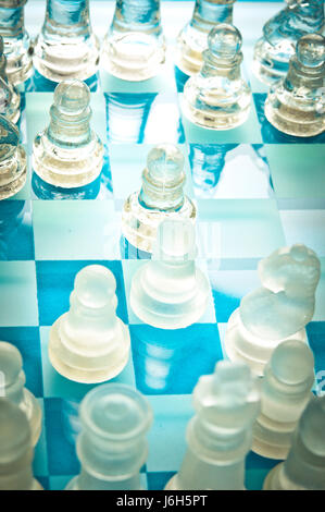 chess pieces and chessboard in glass, game in progress Stock Photo