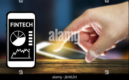 Fintech Investment Financial Internet Technology Concept. Smartphone , blurred finger , application , blurred smartphone and abstract background on wo Stock Photo
