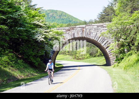 Roanoke Virginia,Blue Ridge Parkway,Appalachian Mountains,stone bridge,cyclist,bicycle,bicycling,riding,biking,rider,bike,man men male adult adults,VA Stock Photo