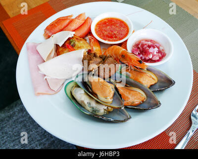 Thai people serve cuisine on plate at food buffet service in restaurant of Hotel in Thailand Stock Photo