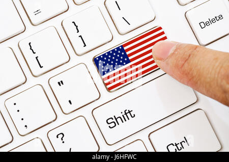 Hand press Computer keyboard with the US flag on it. Stock Photo