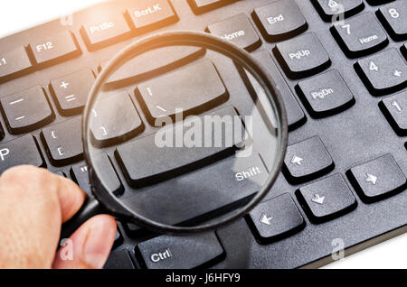 Magnifying glass on a computer keyboard, search, online shopping and business concepts. Stock Photo