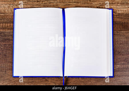 Vintage book open on old wooden table. Stock Photo