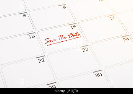 Save the Date written on a calendar page. Stock Photo