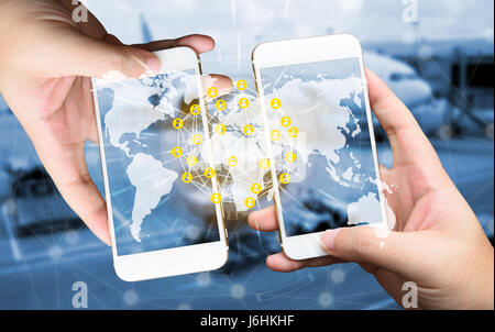 Two Businessman hands holding smartphones. Fintech concept , Peer-to-peer , logistic concept with map and world connect , airplane in airport blue bac Stock Photo
