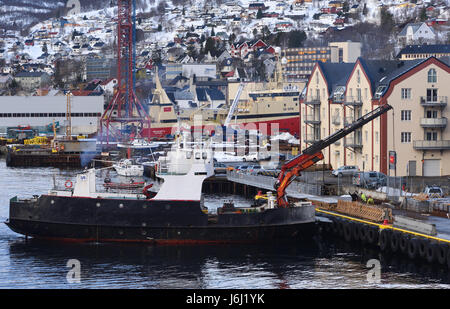 Cranes and ships on the waterfront of  Harstad harbour in winter. Harstad, Troms, Norway. Stock Photo