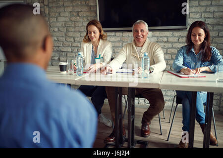 smiling business people team talking about candidate at job interview in the office Stock Photo