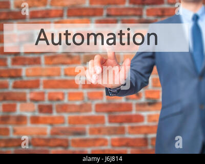 Automation - Businessman click on virtual touchscreen. Business and IT concept. Stock Photo Stock Photo