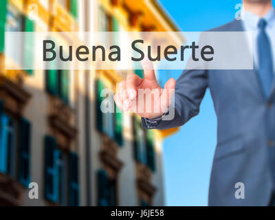 Buena Suerte ( Good Luck in Spanish) - Businessman click on virtual touchscreen. Business and IT concept. Stock Photo Stock Photo