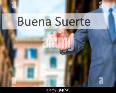 Buena Suerte ( Good Luck in Spanish) - Businessman click on virtual touchscreen. Business and IT concept. Stock Photo Stock Photo