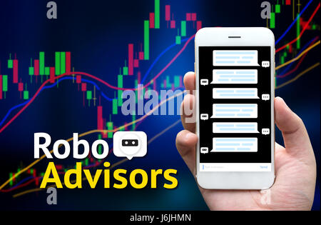 Cyber communication and robotic concepts. robo advisor concept. Text and hand holding smart phone with chat bot screen. blur stock market chart backgr Stock Photo