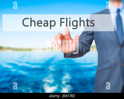 Cheap Flights - Businessman press on digital screen. Business,  internet concept. Stock Photo Stock Photo