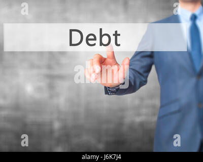 Debt - Businessman hand pushing button on touch screen. Business, technology, internet concept. Stock Image Stock Photo