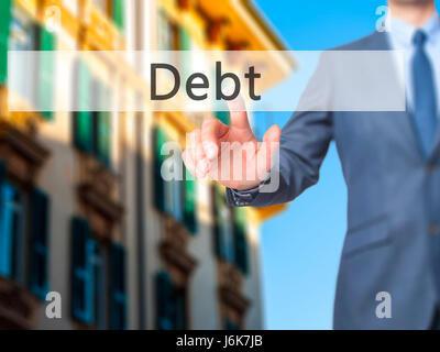 Debt - Businessman hand pushing button on touch screen. Business, technology, internet concept. Stock Image Stock Photo