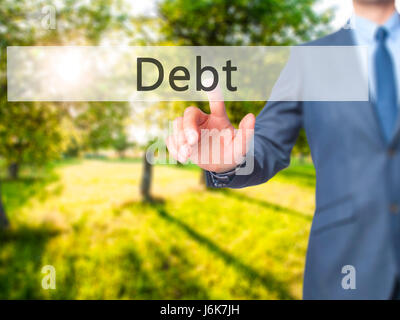 Debt - Businessman hand pushing button on touch screen. Business, technology, internet concept. Stock Image Stock Photo