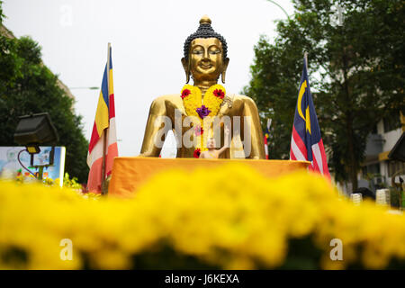 A big golden buddha statue on a Wesak day procession floats at Brickfield Maha Vihara buddhish temple, KL Malaysia. Stock Photo