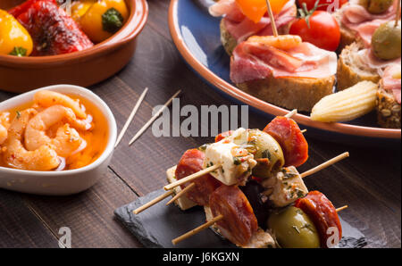 Mixed spanish tapas starters on old wooden table Stock Photo