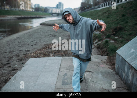 Male rapper posing on the street, urban dancing. Modern dance style Stock Photo