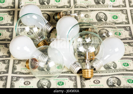 Light bulbs of many different kinds on money Stock Photo