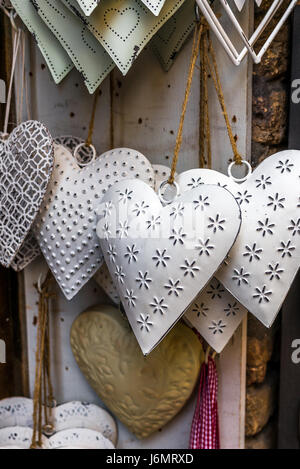 Tin hearts hanging on a window in San Gimignano Stock Photo