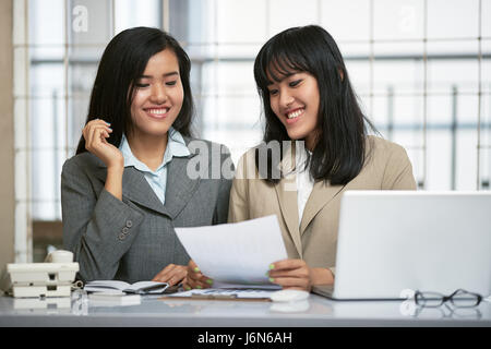 close up image of two businesswomen working and discussing in office Stock Photo