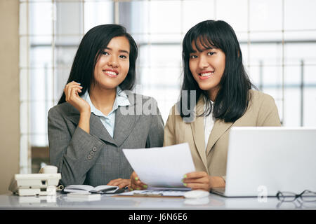 close up image of two businesswomen working and discussing in office Stock Photo