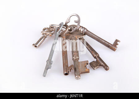 Set of old keys on a white surface. Old keys isolated on white background. Stock Photo