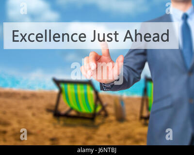 Excellence Just Ahead - Businessman hand pressing button on touch screen interface. Business, technology, internet concept. Stock Photo Stock Photo