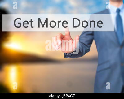 Get More Done - Businessman hand pressing button on touch screen interface. Business, technology, internet concept. Stock Photo Stock Photo