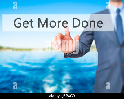Get More Done - Businessman hand pressing button on touch screen interface. Business, technology, internet concept. Stock Photo Stock Photo