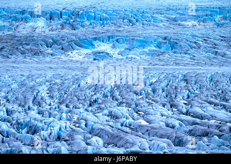 Harsh glaciers of Arctic. Live glacier. Icefall on high rock bar. Novaya Zemlya archipelago, North island. View from helicopter Stock Photo