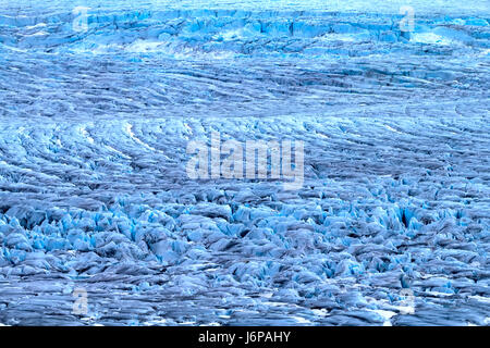 Harsh glaciers of Arctic. Live glacier. Icefall on high rock bar. Novaya Zemlya archipelago, North island. View from helicopter Stock Photo