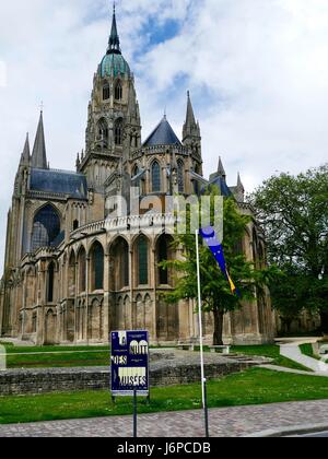 Bayeux Cathedral, Cathédrale Notre-Dame de Bayeux, with sign for La Nuit de Musées, Museum Night, in foreground, Bayeux, Calvados, France. Stock Photo